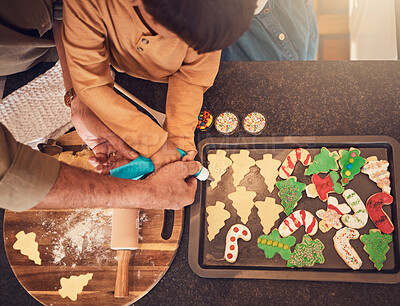 Buy stock photo Christmas, above and a family baking cookies, help with food and process of decoration. Hands, child and teamwork for icing sweet dessert or biscuits for a festive holiday in the kitchen together