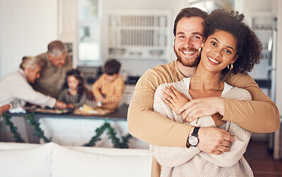Buy stock photo Couple, portrait and hug with love on christmas in family home for quality time with interracial people. Love, embrace and man or woman with happy face in kitchen for bonding during festive season.