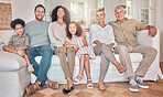 Happy big family, portrait and relax on sofa together for holiday weekend, break or bonding at home. Parents, grandparents and children smile in happiness for quality time on couch in living room