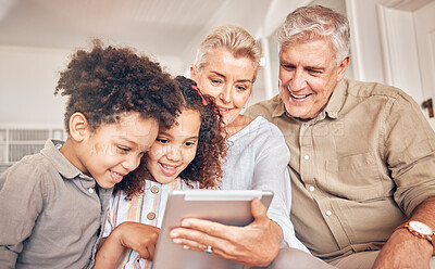 Buy stock photo Happy, children and grandparents with a tablet in a house, streaming cartoon or a movie online. App, smile and interracial kids and senior man and woman with technology for a film, game or website