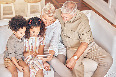 Buy stock photo Grandparents, tablet and children in home, learning and bonding together in living room. Technology, multiracial kids and grandpa and grandma in lounge streaming movie, video or film on social media