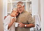 Coffee, love and retirement with a senior couple hugging in their home together while bonding in the morning. Kitchen, smile or romance with a happy mature man and woman drinking tea in their house