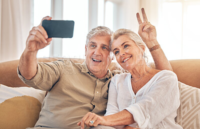 Buy stock photo Happy senior couple, peace sign and selfie in relax on living room sofa for photograph, memory or vlog at home. Elderly man and woman smile for picture, photo or social media on lounge couch together