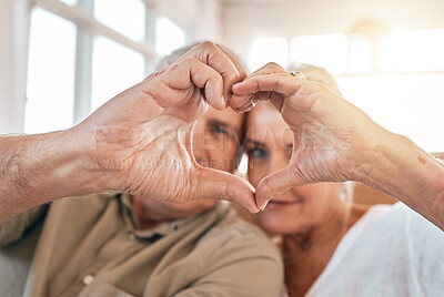 Buy stock photo Senior couple, heart hands and love for support, care or trust in compassion or relationship at home. Closeup of elderly man and woman touching hand together for loving emoji, symbol or sign in house