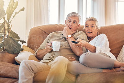 Buy stock photo Senior couple, watching tv and sofa in relax for streaming, movie or series in living room at home. Elderly man and woman with coffee and remote together for changing channel and online entertainment