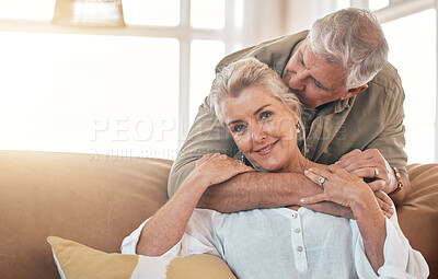 Buy stock photo Senior, portrait and a couple kiss and hug on the living room sofa for love, care and bonding. Happy, house and an elderly man and woman with romance together for gratitude, retirement and kindness