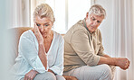 Senior couple, divorce and headache in fight, conflict or argument on the living room sofa at home. Elderly man and frustrated woman in depression, cheating affair or toxic relationship in the house