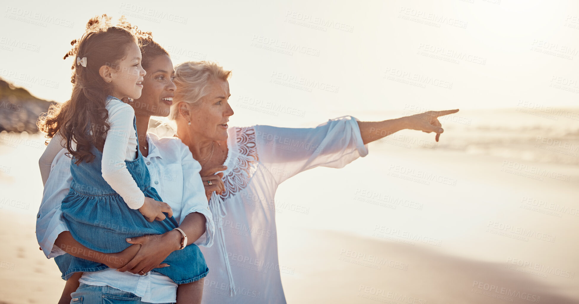Buy stock photo Family, summer and vacation while pointing at the beach on holiday or adventure together. Women or a mother and grandmother with a girl kid outdoor for fun, happiness and learning about nature