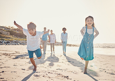 Buy stock photo Happy, excited and children playing on the beach on family vacation, holiday or adventure in summer. Young girl and boy or kids and parents outdoor with fun energy and happiness while playing a game