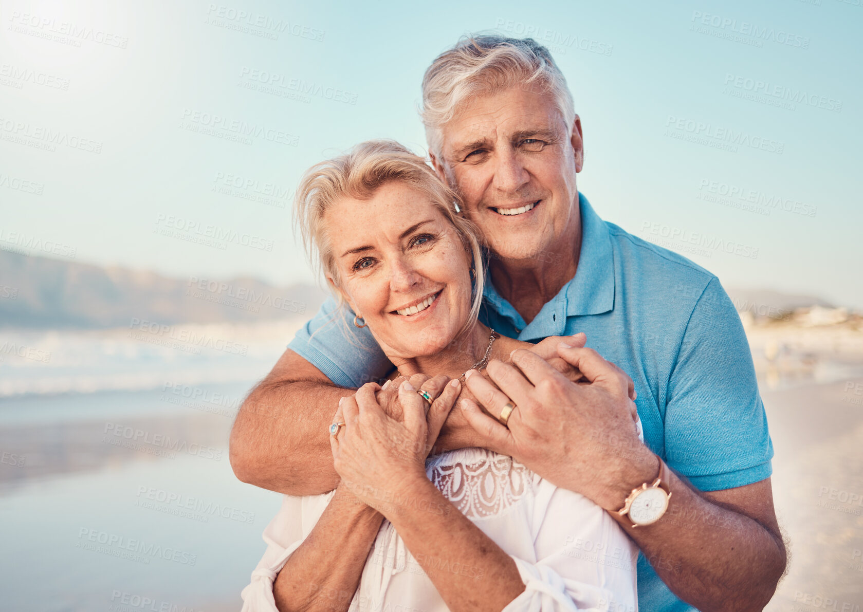 Buy stock photo Beach, love and portrait of senior couple hugging in nature, holiday or romantic outdoor date together at the ocean, sea or sand. Happy, smile and people in a hug, embrace or happiness on anniversary