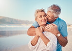 Beach, love and senior couple with a kiss in nature, holiday or romantic outdoor date together at the ocean or sea. Happy, smile on face and people in a hug, embrace or happiness on anniversary