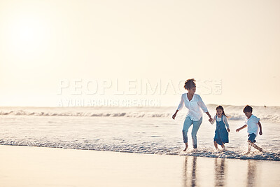 Buy stock photo Playing, mother and children at beach on a fun family vacation, holiday or nature adventure at sunset. Young boy and girl holding hands with a woman outdoor for fun energy, happiness and banner space