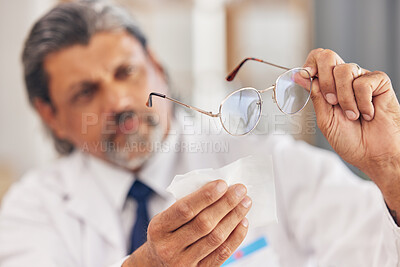 Buy stock photo Hands, medical and an optometrist cleaning glasses in his office for vision, eyesight or hygiene. Healthcare, prescription and frame lenses with a medicine professional holding eyewear in an office