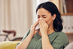 Sick, allergy and blowing nose with woman on sofa for virus, hayfever or illness. Healthcare, disease and allergies with person and sneezing with tissue in living room at home for influenza and sinus
