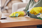 Hands, gloves and cleaning service a table in a home with safety from germs or dirt. Cleaner, dust and rubber protection with spray for household maintenance with a woman in a clean apartment