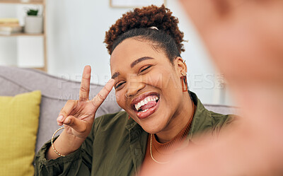Buy stock photo Portrait, happy black woman and peace for selfie in living room, live streaming and home vlog. Face of female gen z show v sign, hand emoji and tongue out for memory, profile picture and social media