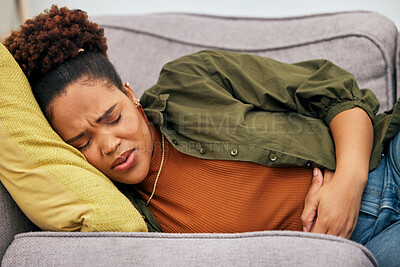 Buy stock photo Sick woman, stomach pain and problem on sofa for ibs, health risk or nausea of gastric bloating, period cramps or virus. Black female person, menstruation or stress of constipation from endometriosis