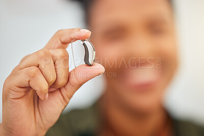 Buy stock photo Hearing aid, hands and person with disability for medical support, listening or healthcare innovation. Closeup of deaf patient with audiology implant, amplifier tech or accessory to help sound waves