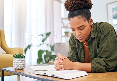 Buy stock photo Young woman, bible and prayer in home, desk and mindfulness for faith, religion and reading with hope for future. African lady, praying hands and study holy book for peace, meditation or worship God