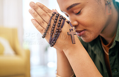Buy stock photo Young woman, prayer and rosary in home, focus and mindfulness for faith, religion and gratitude with hope. African girl, praying hands and cross jewellery for peace, mental health or worship to God