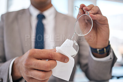 Buy stock photo Lens, man and cleaning and glasses with hand or fabric in office to wipe dirt in blurry background. Professional, prescription and maintenance with cloth for person with eye care or clear vision.
