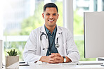 Happy, portrait of man and doctor at table in hospital for healthcare, insurance or wellness. Face, medical professional and confident surgeon at desk, expert smile and employee from Brazil in clinic