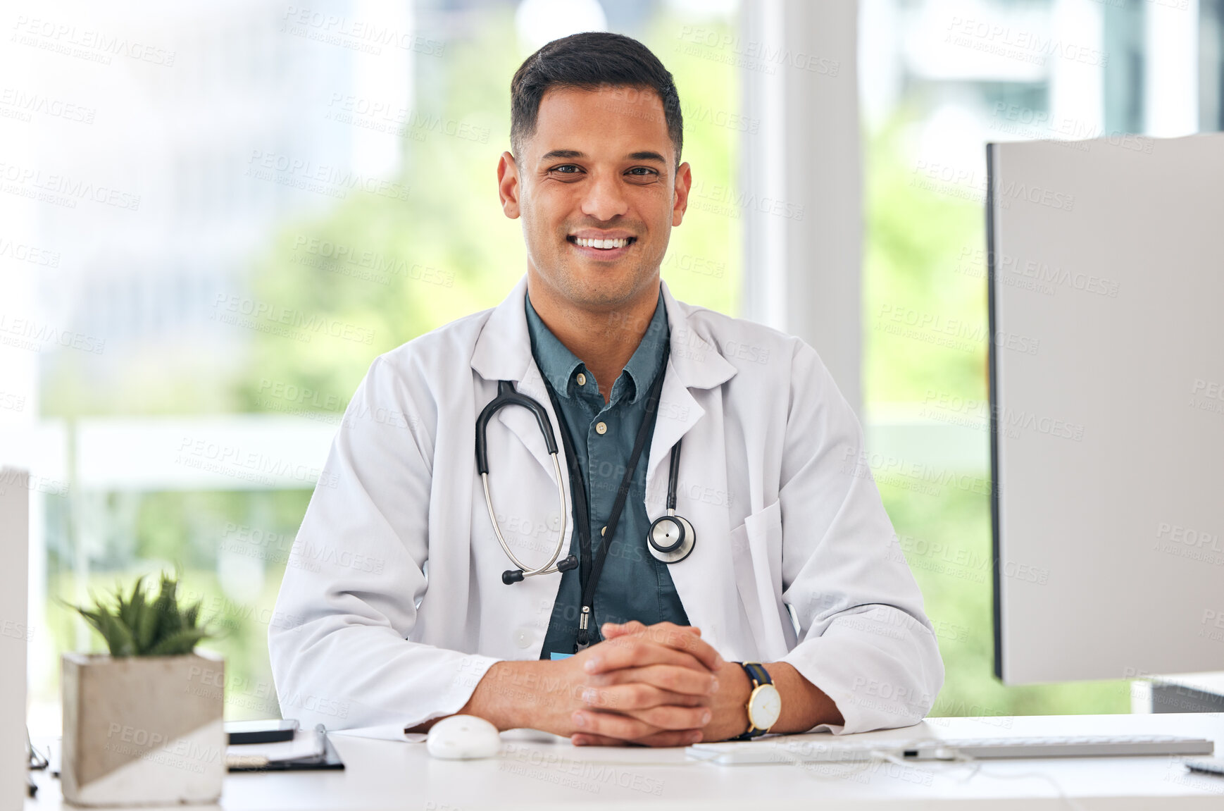 Buy stock photo Happy, portrait of man and doctor at table in hospital for healthcare, insurance or wellness. Face, medical professional and confident surgeon at desk, expert smile and employee from Brazil in clinic