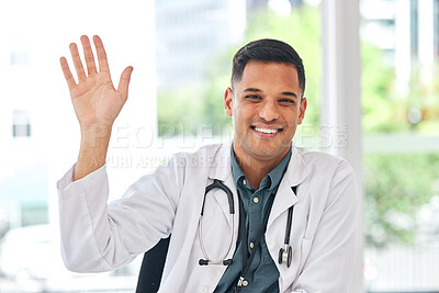 Buy stock photo Doctor, portrait and wave with smile at desk for video call, telehealth service and hello for kindness. Young medic man, sign language and respect with introduction, happy and webinar for healthcare