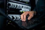 Hands, laptop and typing in server room, man and inspection with coding, analysis and night for programming. Information technology expert, computer and keyboard for database, solution or maintenance