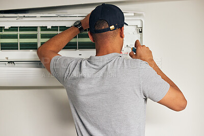 Buy stock photo Maintenance, air conditioner and man with screwdriver for problem solving on machine from back. Aircon, ac repair and handyman service with technician, electrician or contractor work on ventilation.