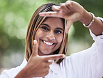 Portrait, smile and finger frame with a woman in nature, outdoor on a green background for travel or freedom. Face, photograph and a happy young female person standing in a park for a profile picture