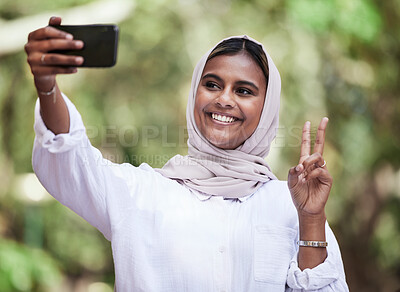 Buy stock photo Selfie, peace sign and student with muslim woman in park for social media, relax and happy. College, smile and happiness with female person in nature for profile picture, blog and gen z post