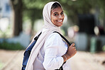 Hijab, student and portrait of woman on campus for university, school and college education happy to travel to class. Smile, Islam and young religious person walking to a lecture for learning