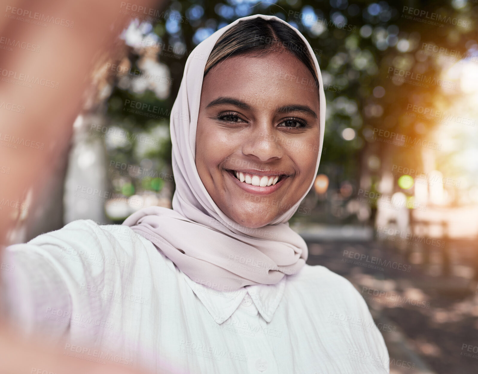 Buy stock photo Selfie, happy and portrait of Muslim woman in park for holiday, freedom and relax outdoors. Social media, hijab and face of Islamic female person with smile for picture, memories and post in nature