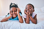 Happy, relax and portrait of children on the bed for playing, bonding and quality time in the morning. Cute, smile and little African kids or siblings in the bedroom of a house for childhood together