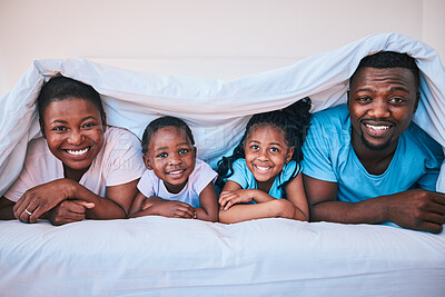Buy stock photo Happy, black family and portrait in a bed with blanket, relax and comfort on the weekend in their home. Face, smile and children with parents in bedroom playing, cover in the morning with fun 