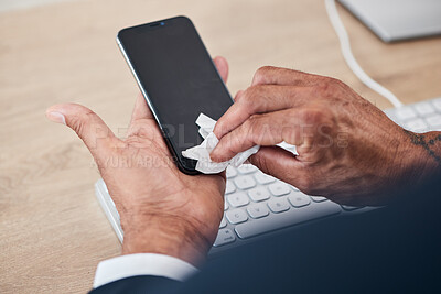 Buy stock photo Closeup of man wipe his phone with a tissue to prevent germs, bacteria or dirt in his office. Technology, hands and male person cleaning cellphone screen for hygiene, health and wellness at workplace