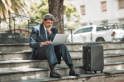 Buy stock photo Travel, email and businessman with laptop in the city for communication and booking a flight online. Serious, working and mature corporate manager with a computer and luggage for a ticket on the web