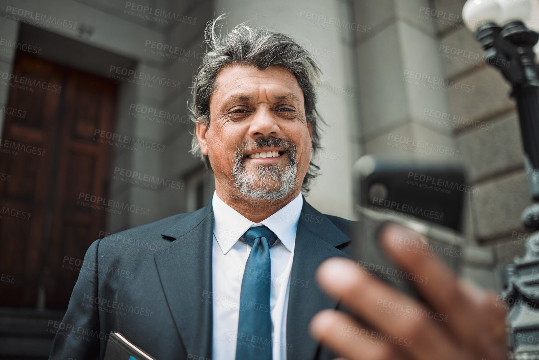 Buy stock photo Happy man, social media or lawyer with phone for news, legal services update or networking online. Smile, mature advocate or senior judge typing on website to scroll, chat or search outside a court 