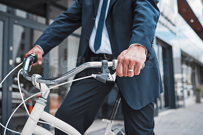 Buy stock photo Hands, bicycle and businessman cycling in the city or riding for eco friendly travel, transport or commute to office, building or work. Man, driving and bike for carbon neutral footprint in town