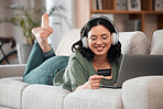 Woman, credit card and headphones on computer online shopping, e learning and fintech payment on sofa. Student or person relax with music subscription, banking services and home education on laptop