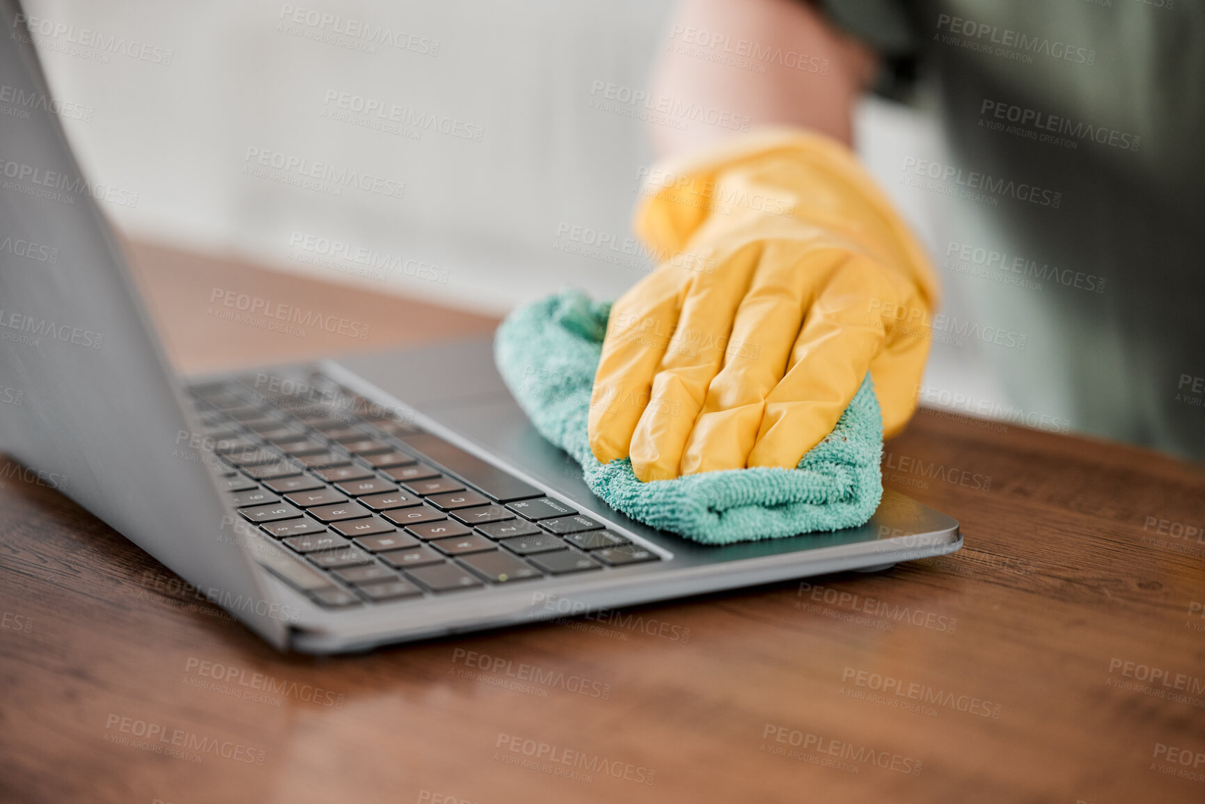 Buy stock photo Person, hands and cleaning laptop for disinfection, bacteria or germ removal on wooden table at home. Closeup of housekeeper, cleaner or maid wiping computer in sanitizing, hygiene or clean equipment