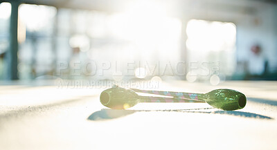 Buy stock photo Fitness, dance and ribbon on the floor of a gym or studio for training with flare on a blurred background. Exercise, creative and equipment with a baton for dancing in an empty health center closeup
