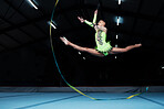 Jump, rhythmic gymnastics and woman in gym with ribbon, motion blur and action, performance and fitness. Competition, athlete and female gymnast, dance and art with body, routine and energy at arena