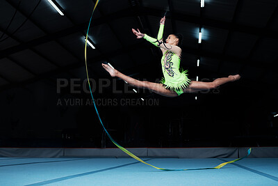 Buy stock photo Jump, rhythmic gymnastics and woman in gym with ribbon, creative sport or action, performance or fitness. Competition, athlete and female gymnast, dance and art with body, routine and energy at arena