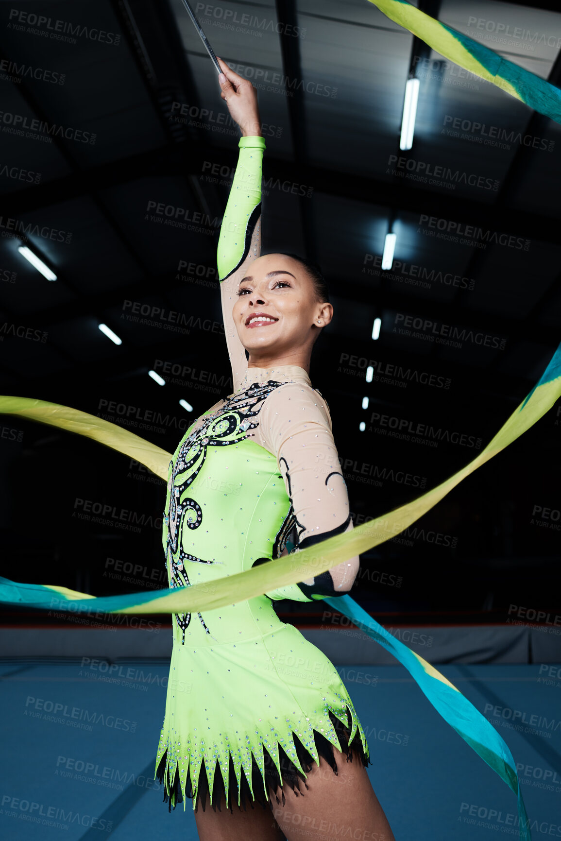 Buy stock photo Happy, woman and rhythmic gymnastics with ribbon in gym, creativity and action, performance and fitness. Competition, athlete and female gymnast, dance and art with body, routine and energy at arena