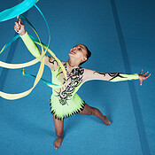 Dance, rhythmic gymnastics and woman in gym with ribbon in air, action ...