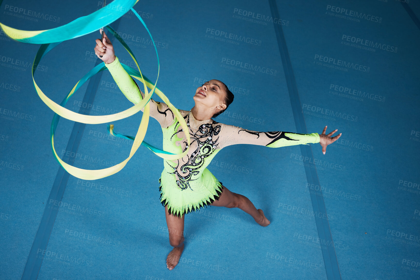 Buy stock photo Dance, rhythmic gymnastics and woman in gym with ribbon in air, action with performance top view and fitness. Competition, athlete and female gymnast, creativity and art, routine and energy at arena
