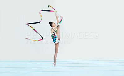 Buy stock photo Gymnastics performance, woman and ribbon with legs split for competition, sport and show on studio floor. Gymnast, athlete girl or professional dancer for balance, training or contest for creativity