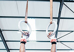 Hands, gymnastics ring and person in fitness for workout, strength training or competition. Closeup of hanging athlete, strong gymnast or acrobat holding on balance circles for performance exercise